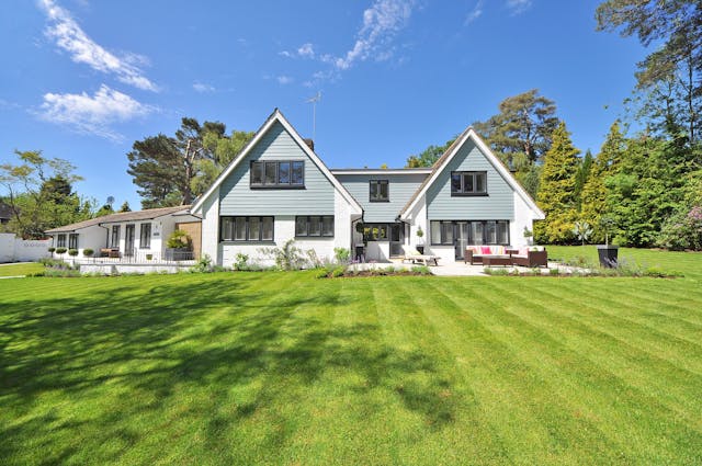 a house with a well maintained, lush green lawn