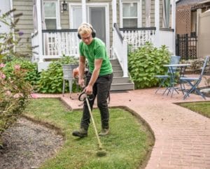 man working on a front lawn