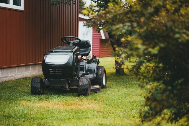 a lawn mower sitting on a bright green lawn