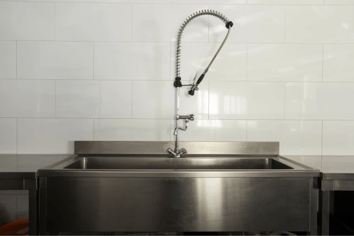 Three-compartment dishwashing sink.