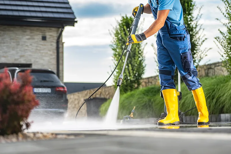 Image a man pressure washing driveway