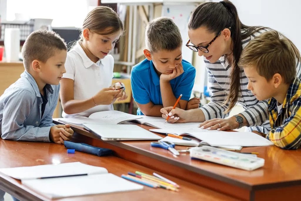 Teacher with group of students explaining homework.