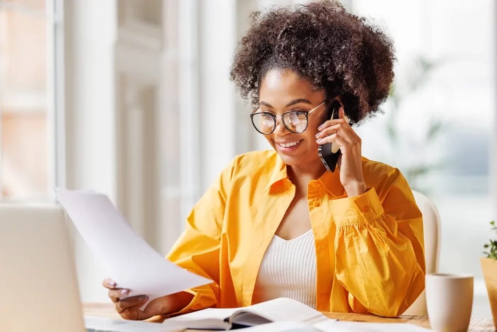 Person on the phone looking at paperwork