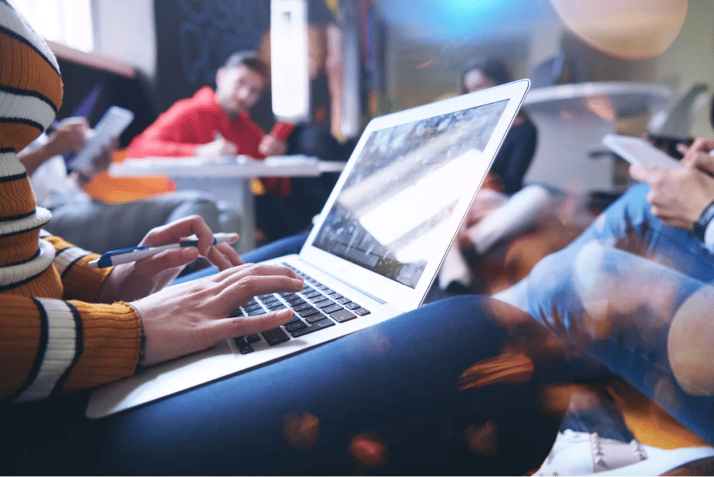 Group of students using laptops and tablets