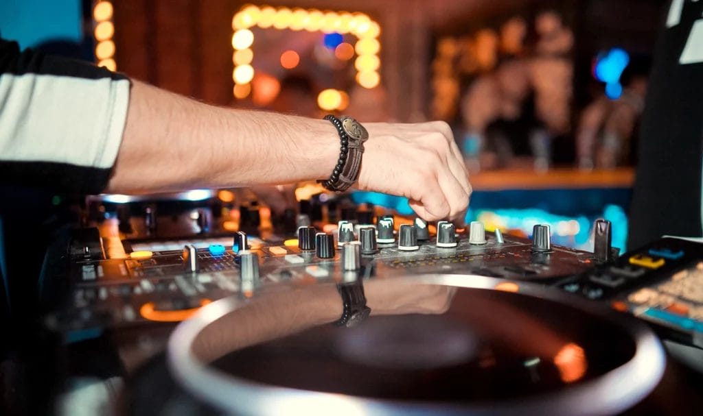 A close-up shot of a wedding DJ spinning records during an event.