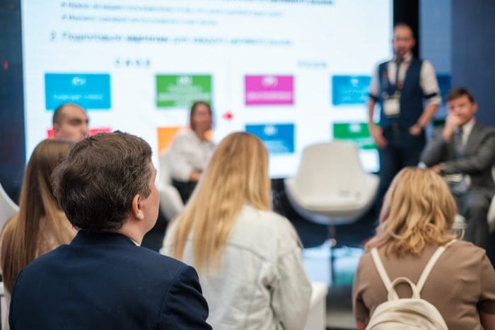 An expert hosts a workshop at a trade show.