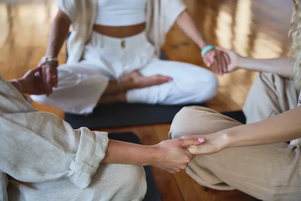 Group of three practicing meditation.