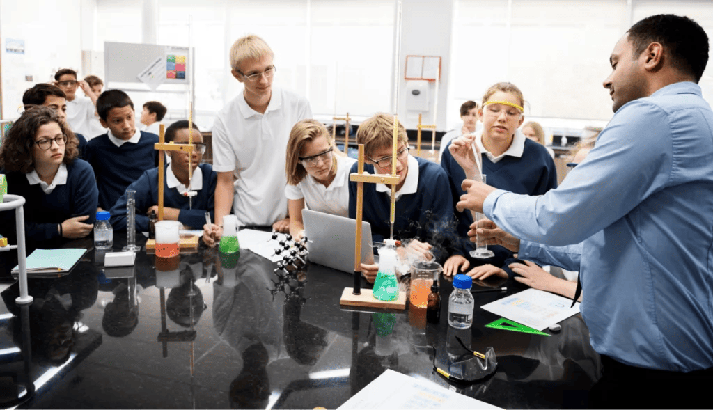 Science teacher demonstrates experiment with students in classroom