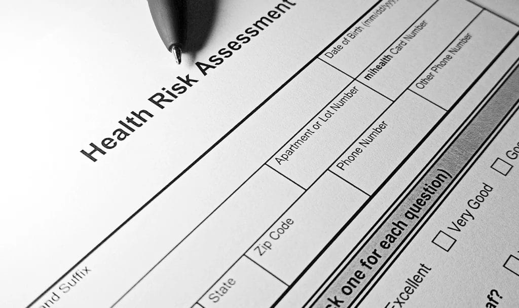 Black and white health questionnaire form with pen near the top.