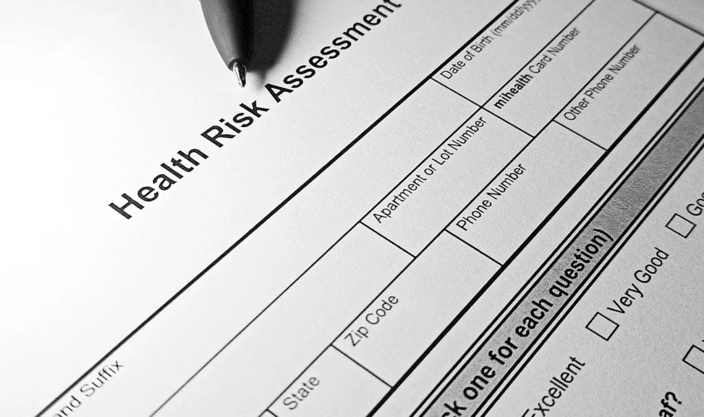 Black and white health questionnaire form with pen near the top.