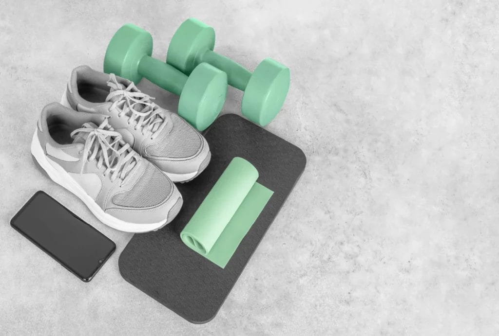 Gray and seafoam green workout equipment on the floor.