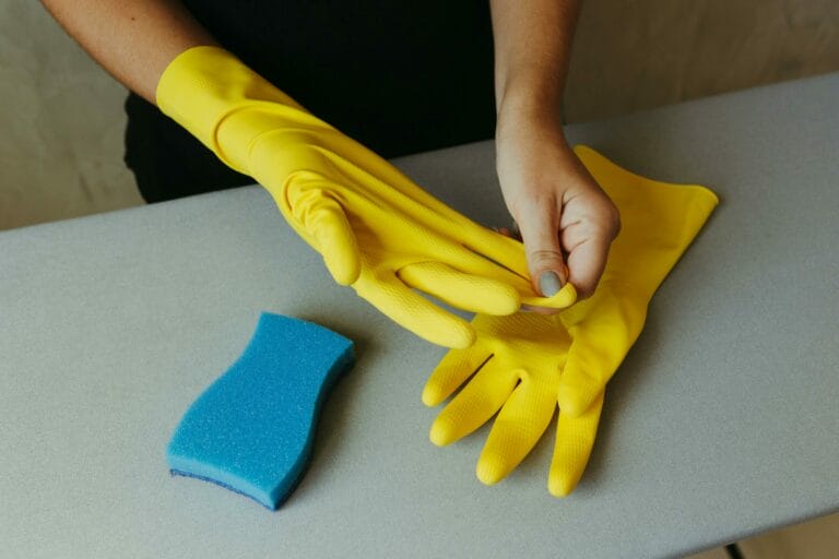 a cleaner pulling yellow rubber gloves off of their hands