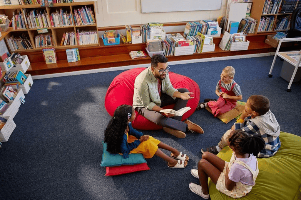 Teacher with a group of students reading a book