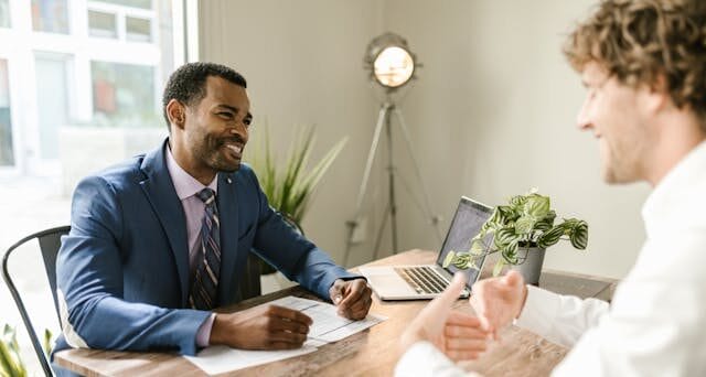 Men Sitting at Table Smiling