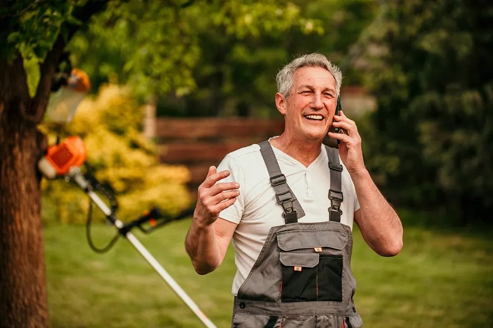 Image of a lawn care professional talking on the phone
