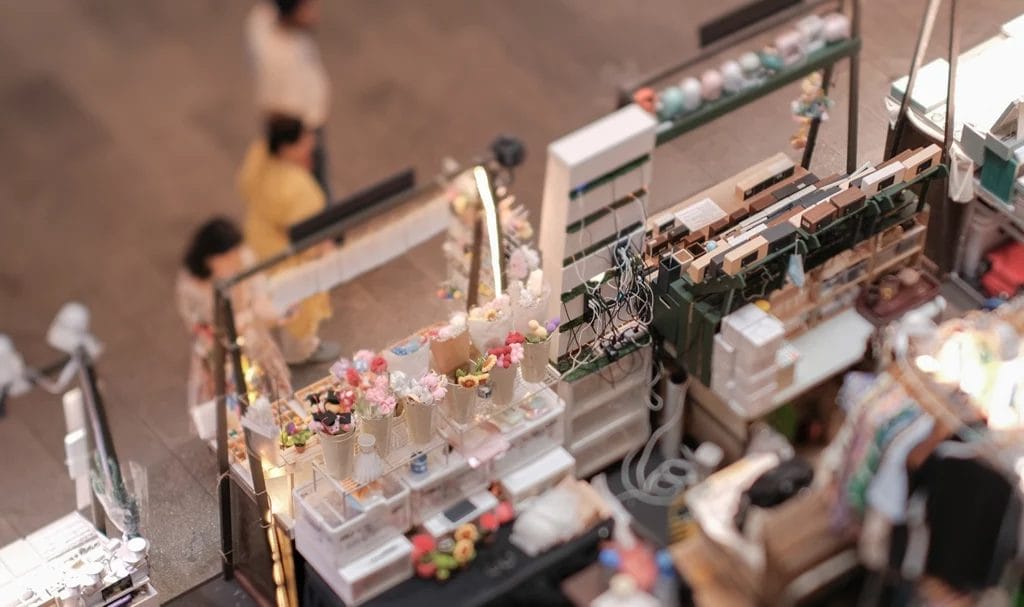 High-angle view of customers at an indoor pop-up event in a shopping mall for entrepreneurs and makers.