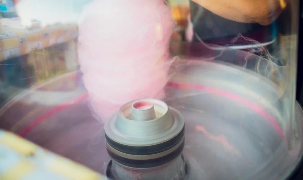 A close-up look at how a food vendor spins cotton candy.