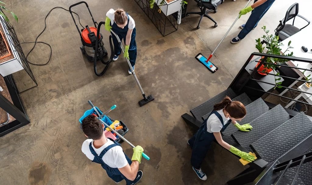 Top view of a cleaning company team cleaning a modern office space.