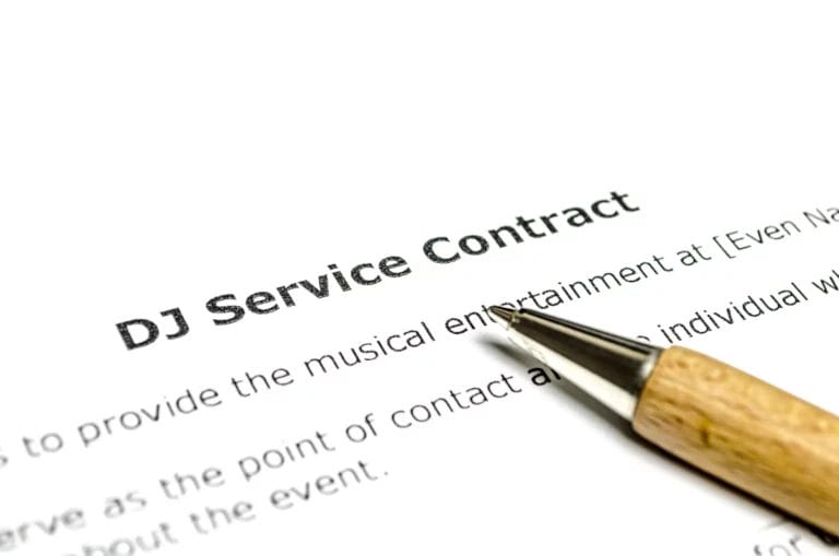 A DJ services contract with a pen.