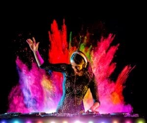 A DJ performing with a glitter bomb.