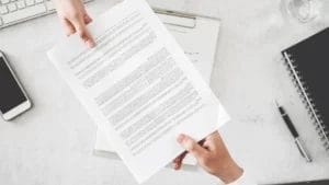 Two people exchanging a contract.