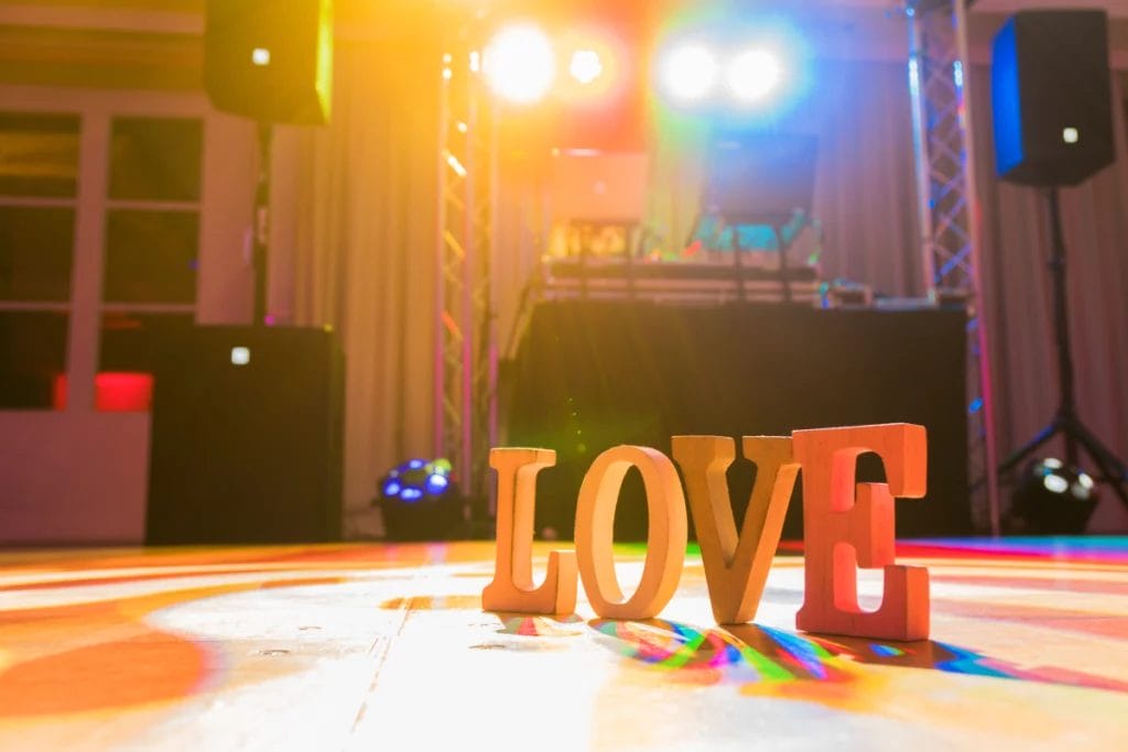 Large letters on dance floor spell, "LOVE."