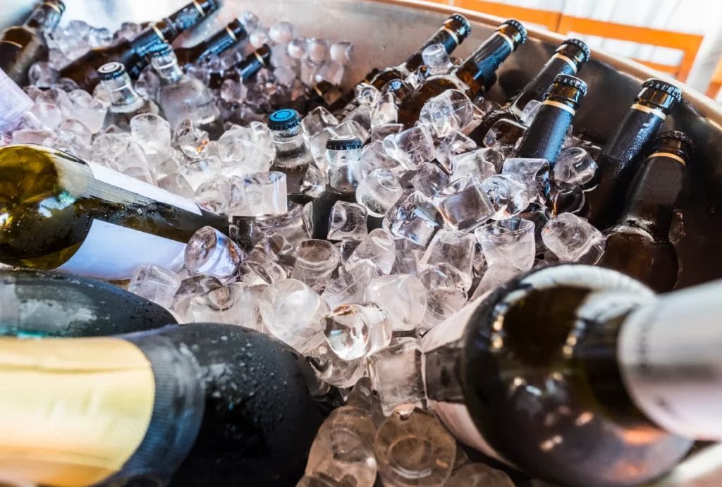 A bucket full of ice and bottles of wine, champagne, and beer.