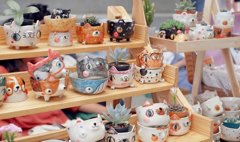 A close-up look at some handmade pottery on display in an artist's vendor booth.