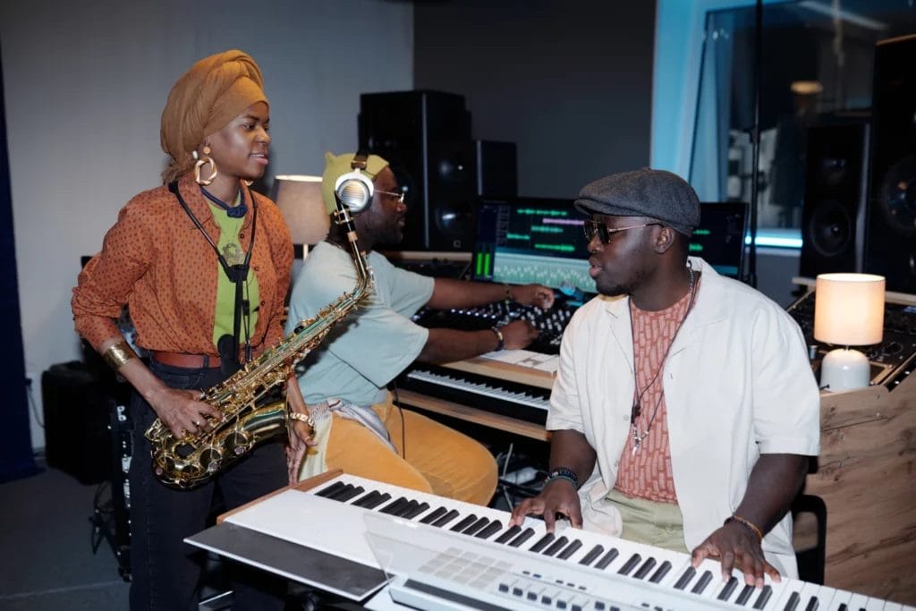 Musicians talking in a recording studio.
