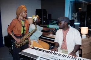 Musicians talking in a recording studio.