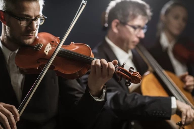 An orchestra playing with instruments.