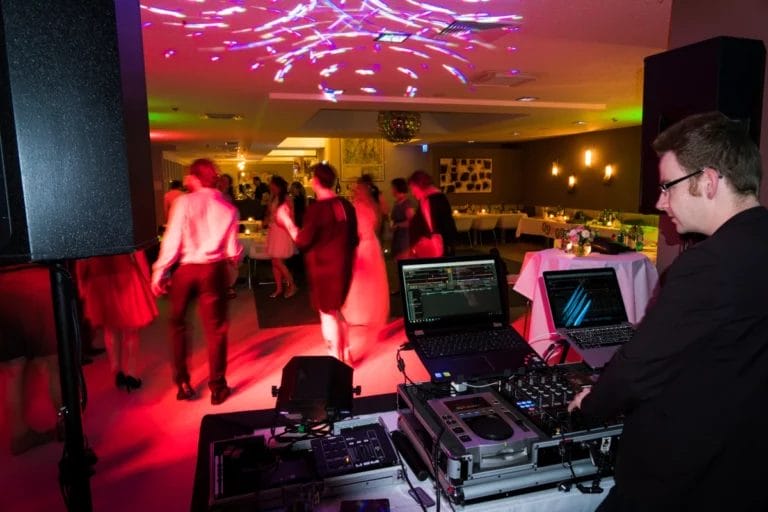 A wedding DJ near the dancefloor.