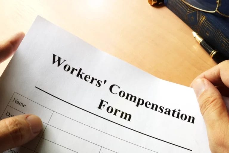 A person holding a workers' comp form.
