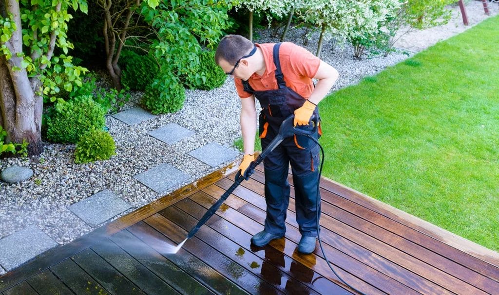 Ariel view of a professional pressure washing an outdoor deck.