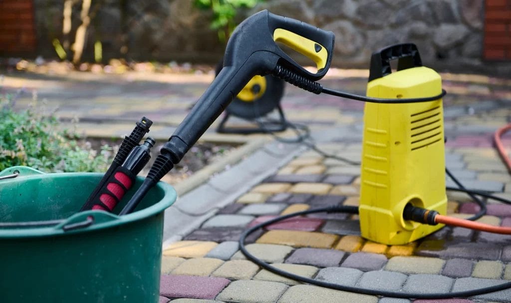 Close-up look at a water compressor on a driveway.