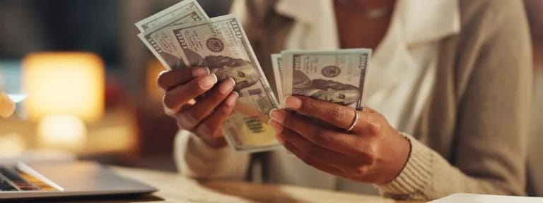 image of woman holding money