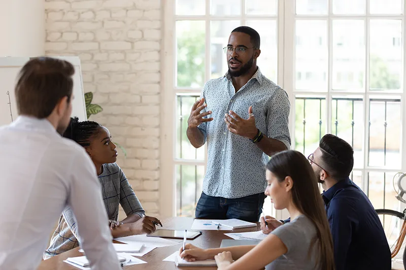 Image of a man talking to his team