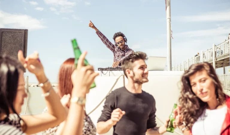 A DJ turning it up at a beach party.