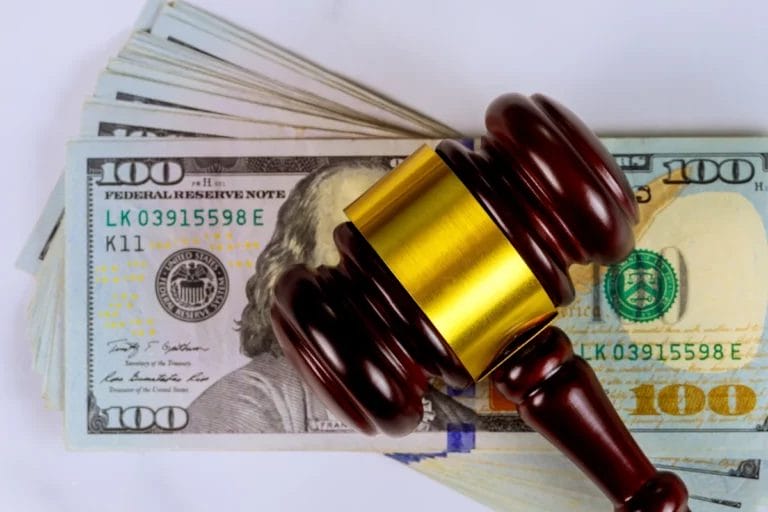 A gavel on a stack of money.