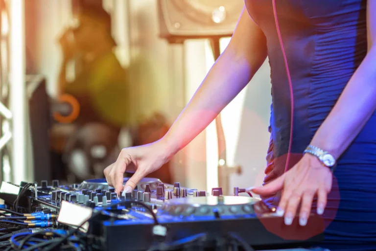 A DJ mixing music at a house party.