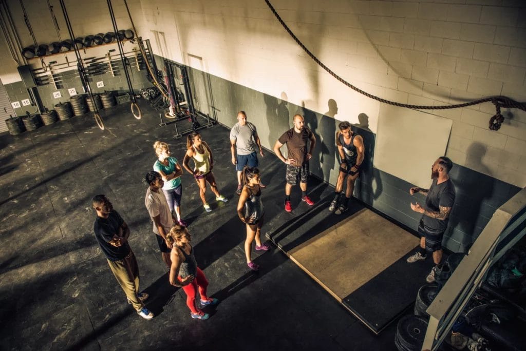 Top view of a coach instructing a CrossFit-style class.