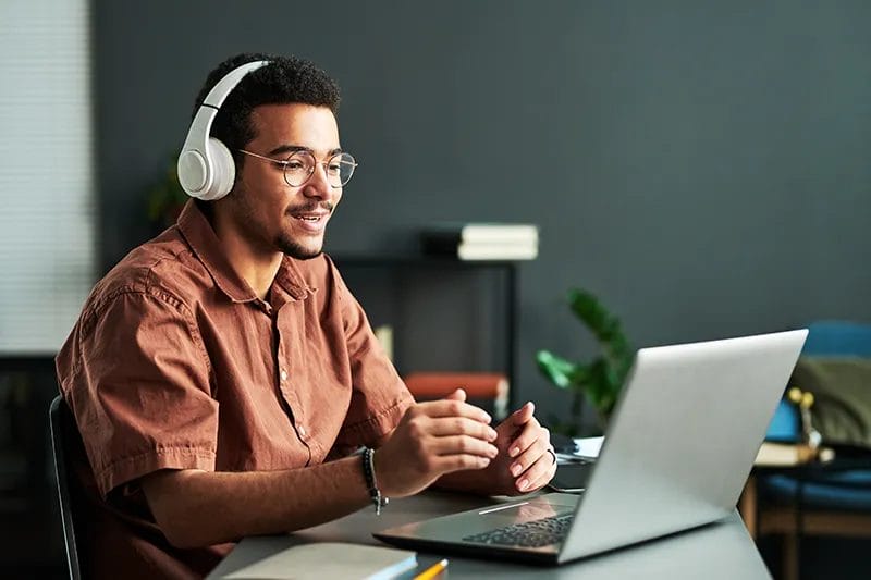 Student with Headphones learning on a laptop