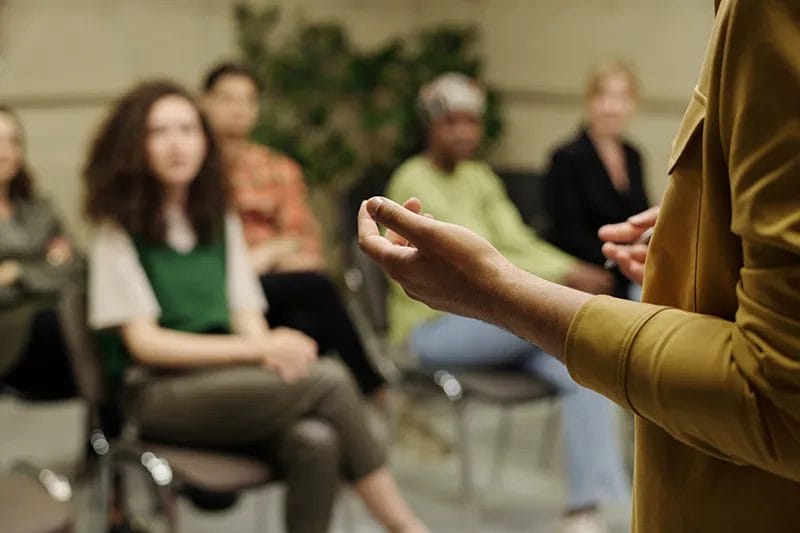 Close up of hands with coaching in a meeting