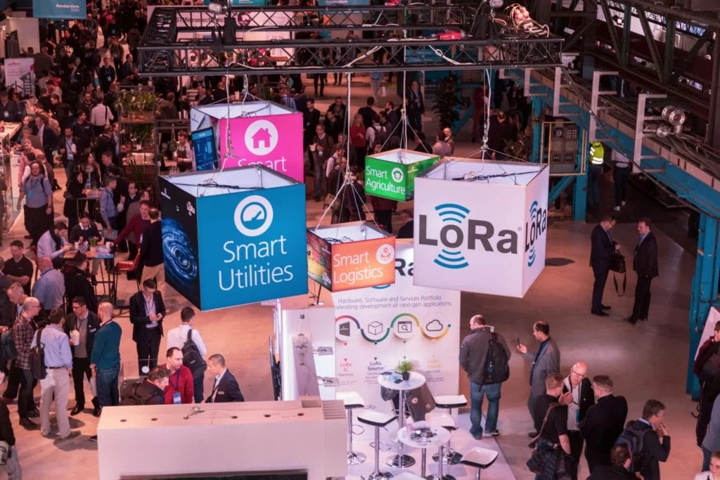displays suspended from the ceiling at a packed trade show