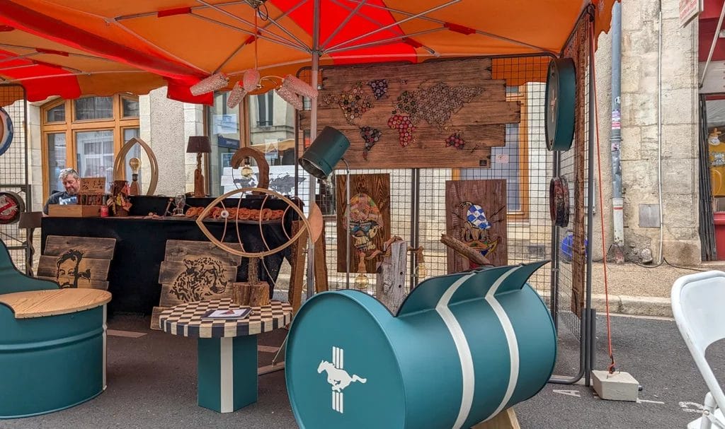 A vendor stall is set up for the day, full of handmade artwork and stylish booth decor.