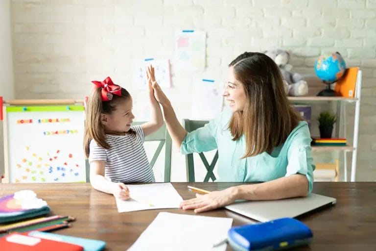 Teacher and student exchange a high-five.