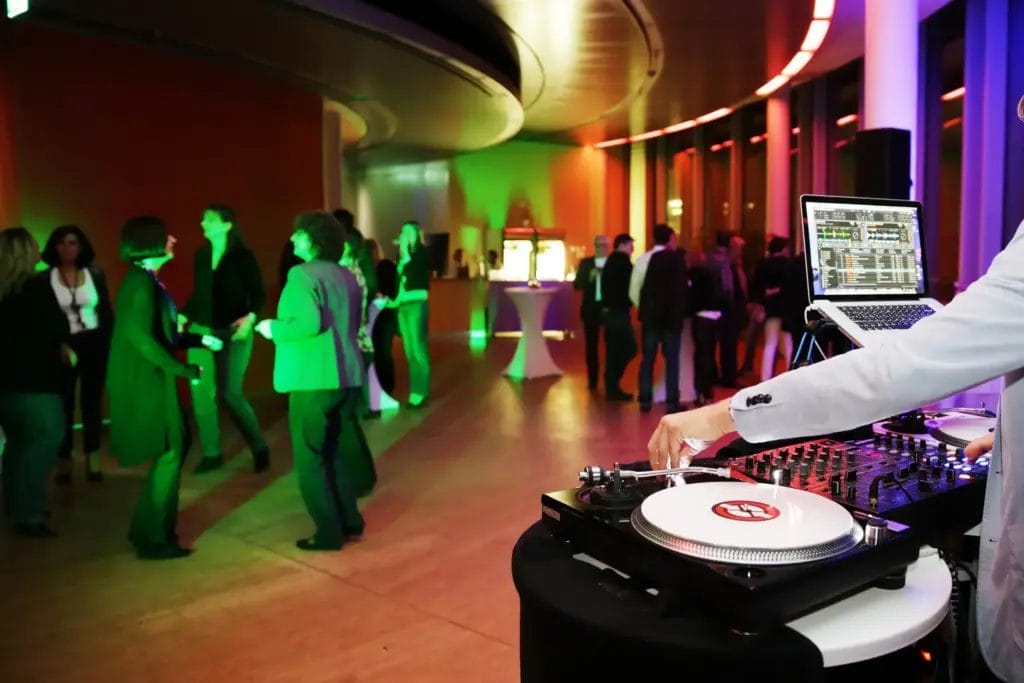 A DJ spinning tracks at a corporate conference.
