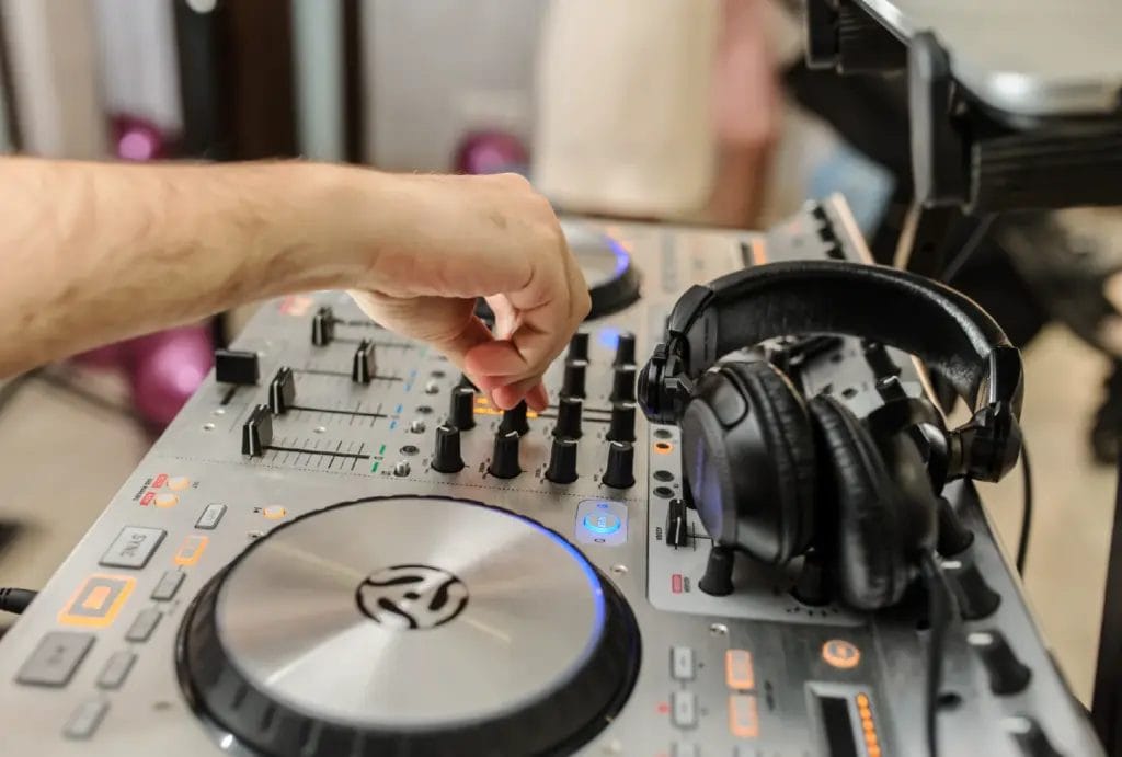 A DJ setting up their booth before the wedding reception.