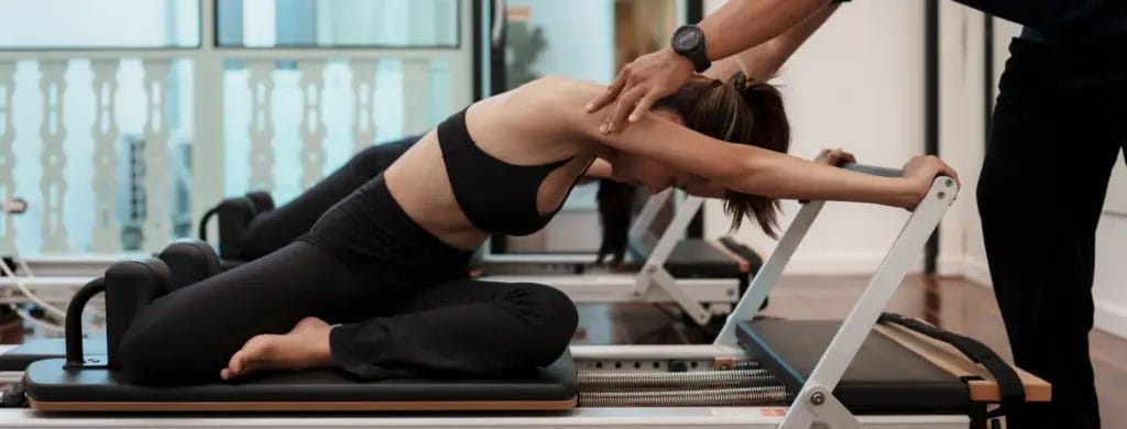 A Pilates student on a Reformer
