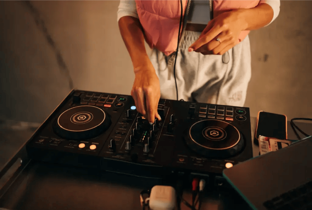 A DJ mixing it up at her booth.